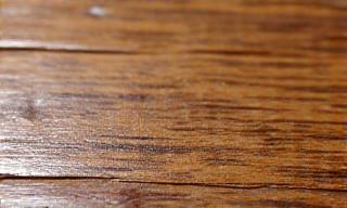 Close-up of a damaged furniture surface.